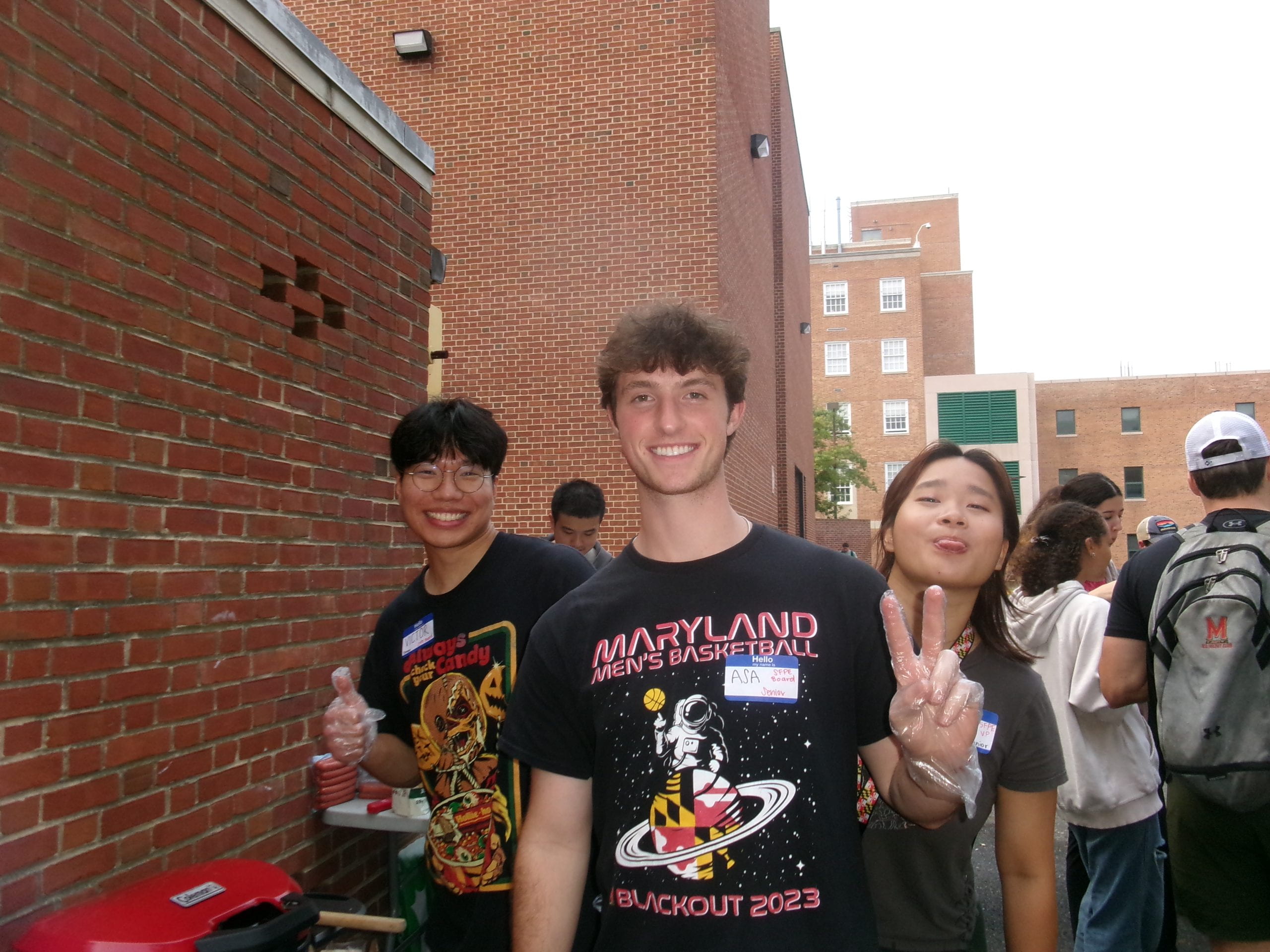 Three students a student-led BBQ social.