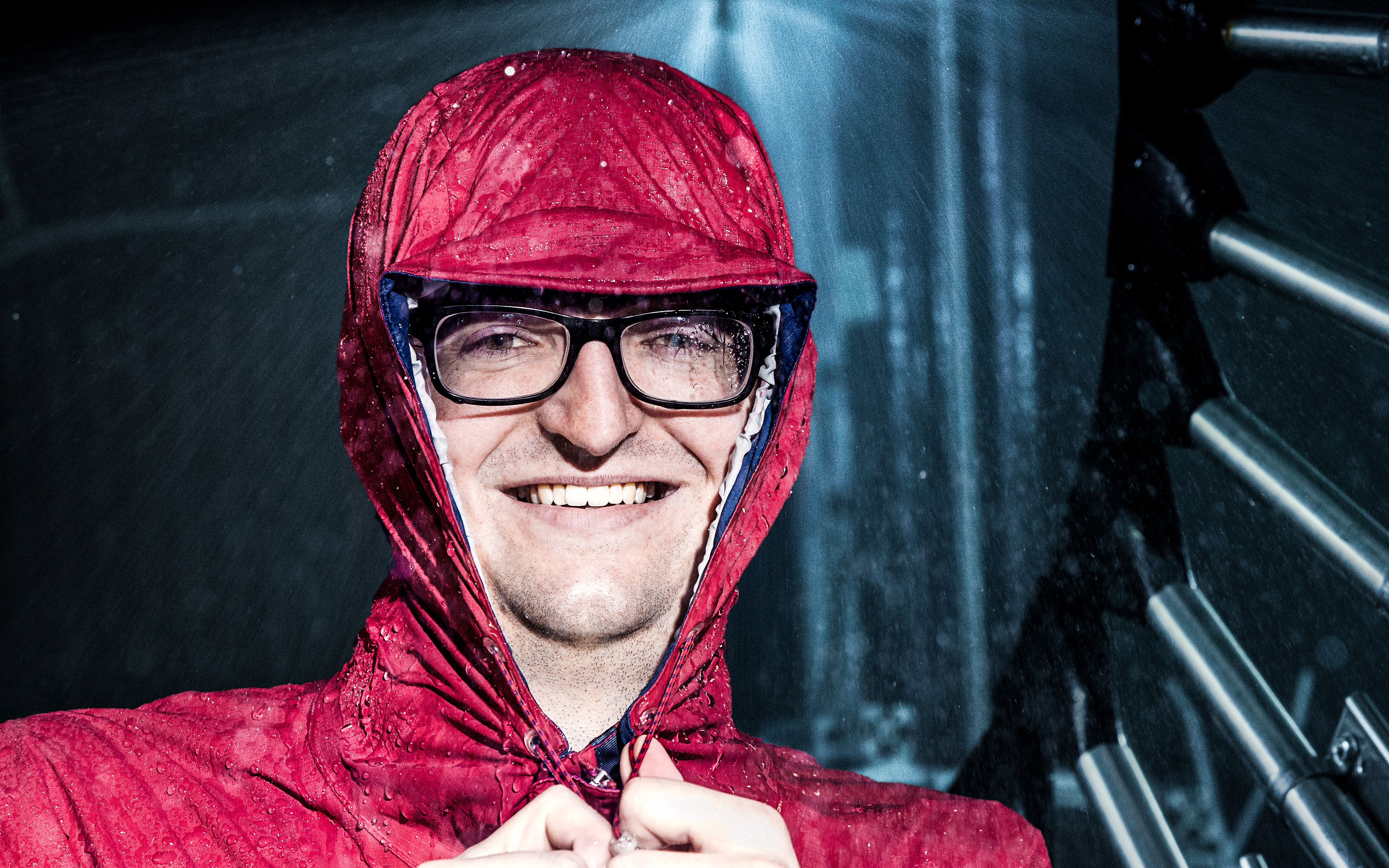 Close up of student wearing rain jacket with water droplets.
