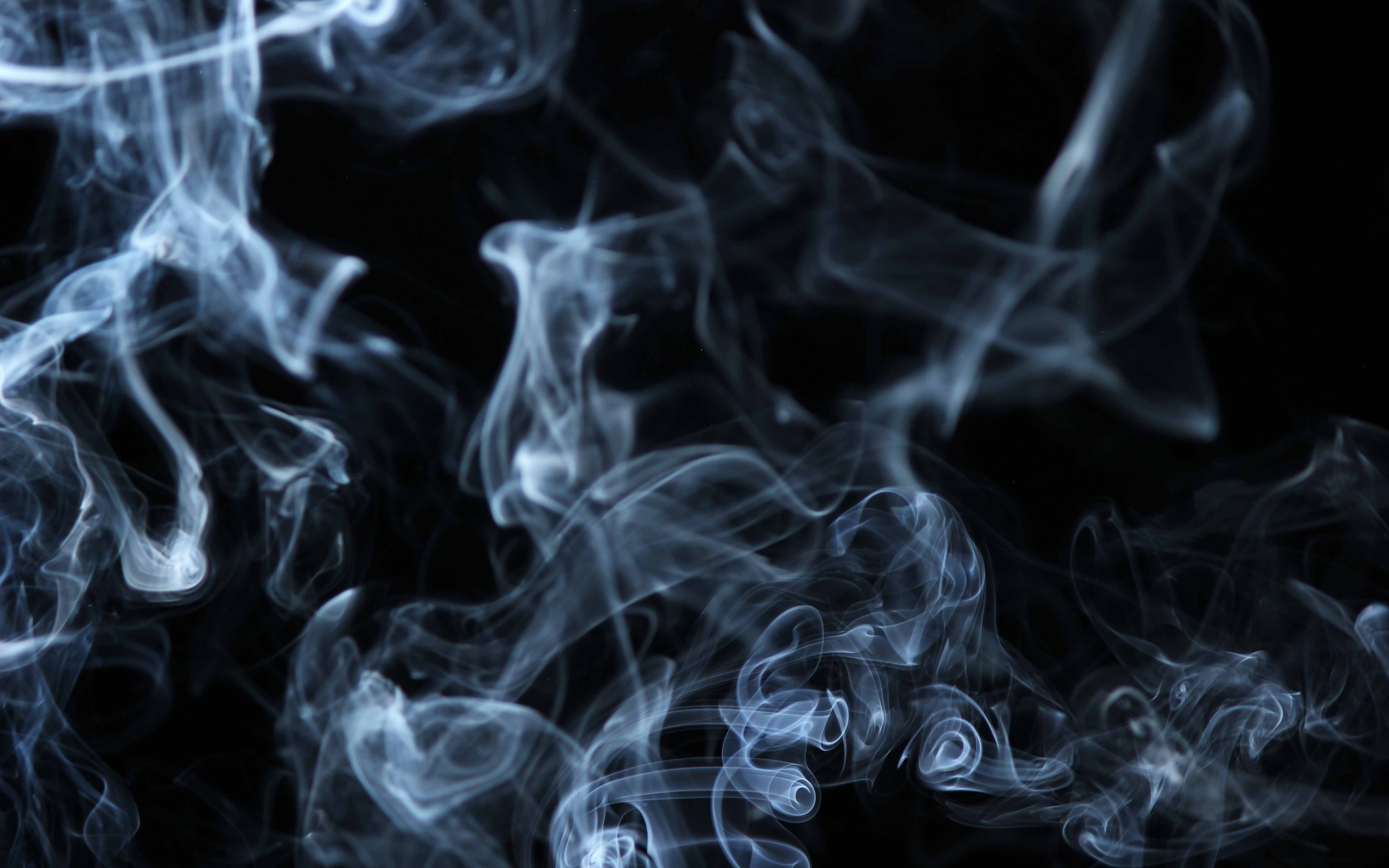 White smoke over black background.