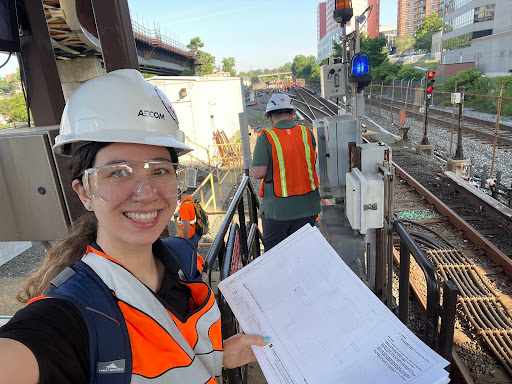 Female student wearing helmet at construction site.