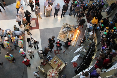 The crowd watches Team FPE's CD-playing device in action.